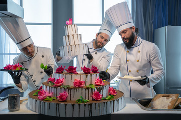 Three chefs baked a cake.