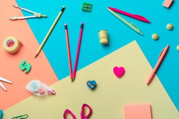 School supplies on a multi-colored background