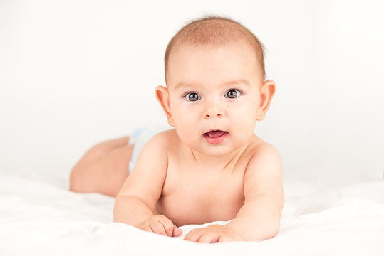 Smiling Happy Newborn Infant Baby Tummy Time On Bed Bright Airy Copy Space Childhood