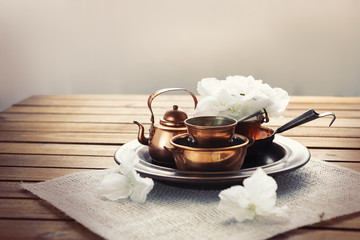 Copper old scratched vintage crockery kitchenware on the table