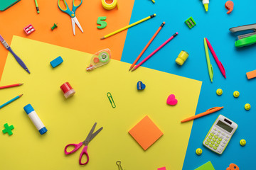 School supplies on a multi-colored background