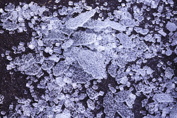 broken transparent glass, covered with dust. small pieces of glass shine and shimmer, reflecting the rays of light.