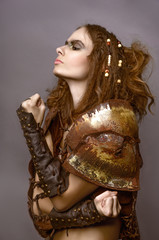 girl warrior in armor on a gray background