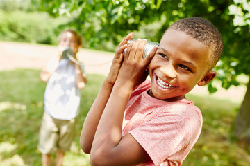 African boy with tin can telephone