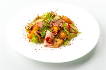 Meat salad with roast beef, mushrooms, potatoes, onions, mix of salad, spices, isolated on white background. Close-up