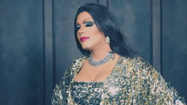 travesty-diva. The concept of the transvestite show. Man-actor turns into a woman. he dances, sings and poses on camera. 4k, slow motion, shooting steadicam