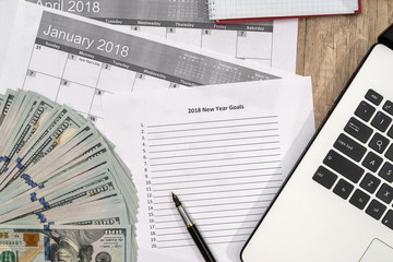 new year goals concept with computer, dollar and coffee