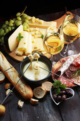 Gourmet Swiss fondue dinner on a winter evening with assorted cheese