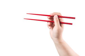 Hand with red chopsticks isolated on a white background