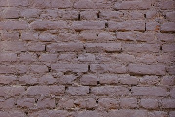 brown stone texture of old bricks in the wall of a building