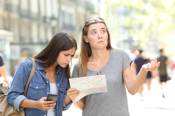 Lost tourists consulting map and phone