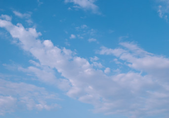 white cirrus clouds on a blue sky