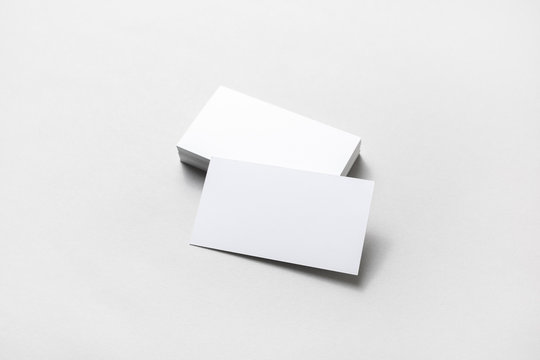 Mockup of blank business cards on paper background.