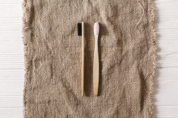 eco natural bamboo toothbrushes flat lay on rustic background.  sustainable lifestyle concept. zero...