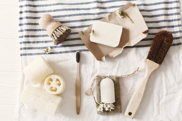 zero waste concept. eco natural plastic free luffa, bamboo toothbrush, brush, coconut soap and...