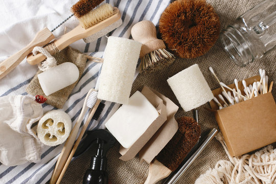 zero waste flat lay. eco natural bamboo toothbrush, brush, crystal deodorant,luffa,ear sticks, metal straws, coconut soap, cotton bags, handmade detergent. sustainable lifestyle concept