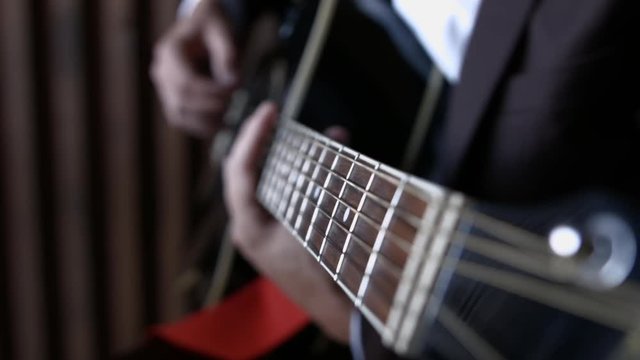 HD Guitarist Tuning Guitar. Close Up of fingerboard
