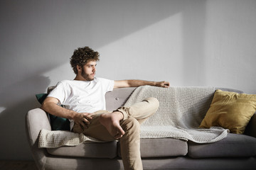 Horizontal shot of fashionable young thirty year old Caucasian bachelor with wavy hair and thick...