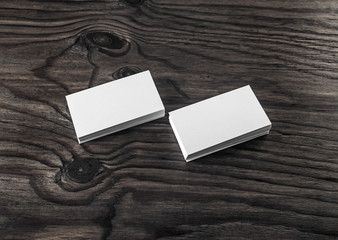 Fototapeta premium Photo of blank business cards on wood table background. Template for ID.