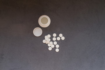 Fototapeta na wymiar pills on grey velvet background