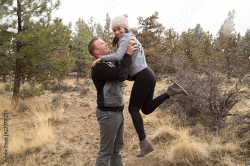 A Husband Swinging His Wife Around During A Snowstorm Stock