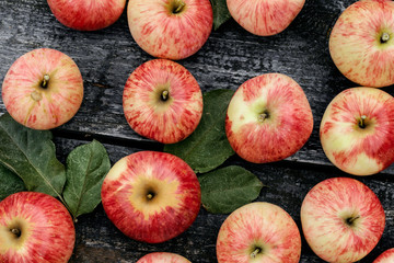 Red ripe apples on old rural background.
