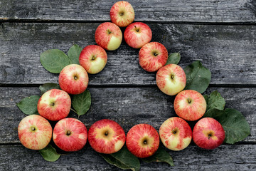 Red ripe apples on old rural background. Place for text. Triangle, vertex, Goals to achievement. .