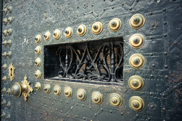 Green metal forged door with golden details
