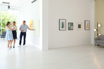 Group of people at exhibition in art gallery