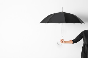 Person holding open umbrella on white background with space for design