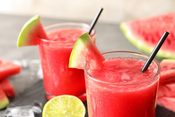 Tasty summer watermelon drink in glasses served on table, closeup
