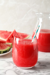 Tasty summer watermelon drink in glass served on table