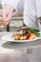 chef plating chicken dinner