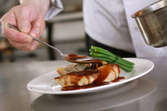 chef plating chicken dinner