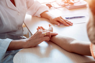Pediatrician measuring girl’s heart rate