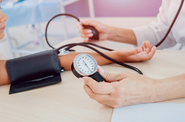 Doctor measuring blood pressure of a little girl.