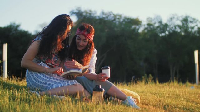 Two girls are discussing an interesting book