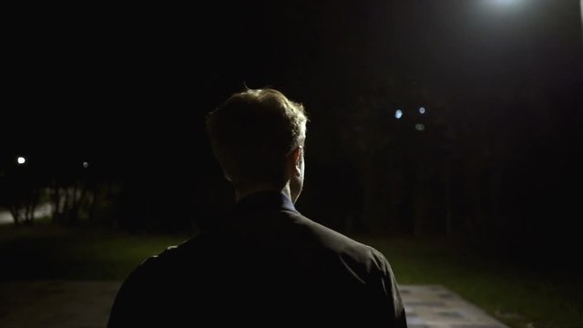 The male walking outdoor. evening night time, slow motion