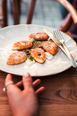 Cottage cheese pancakes served on a white plate. Wooden table. Food photography concept