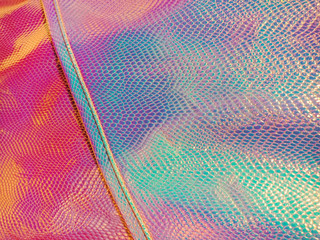 Holographic bright rainbow multicolor skin background.