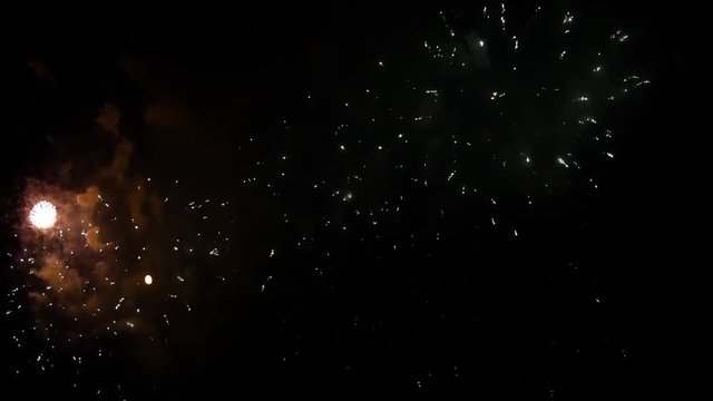 Beautiful fireworks in the night sky with the moon