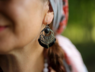 earring in the woman's ear