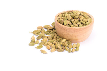 Green Cardamom in wooden bowl, cardamon or cardamum  isolated on white background (dried fruits of Elettaria cardamomum
