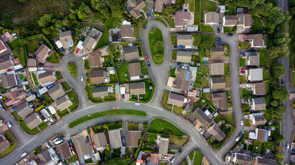Top down aerial view of urban houses and streets in a residential area of a Welsh town - Powered by Adobe