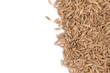Pile of cumin seeds isolated on white background