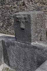 Street water tap in the once buried Roman city of Pompeii south of Naples under the shadow of Mount Vesuvius in Italy

