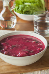 Bowl of Beet and Vegetable Soup with Salad