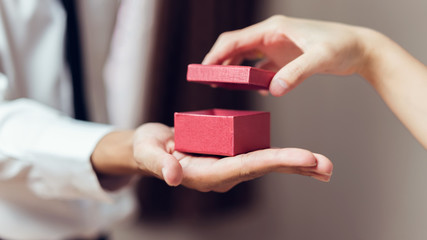 Man holding open the empty red gift box.