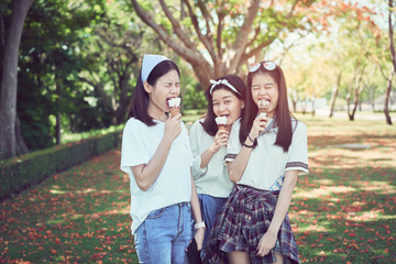Young girl is eating ice cream and happy. At the time of relaxation.