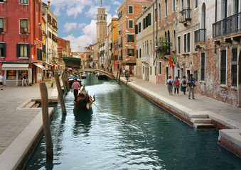 Fototapeta na wymiar Charming canal street with Gondola in Venice, Italy